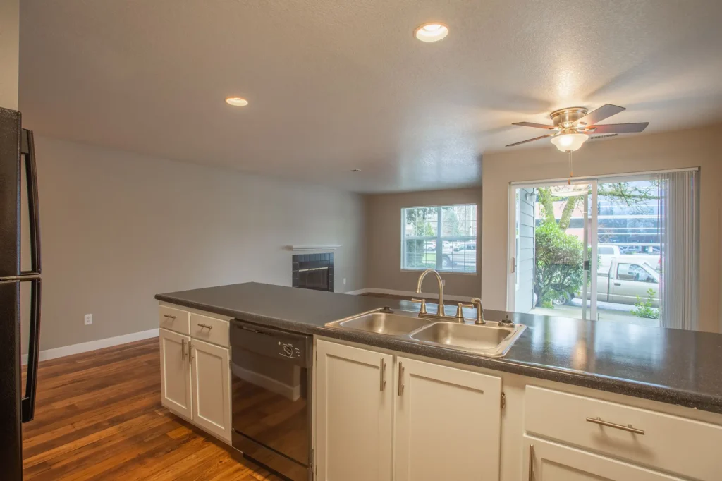 Kitchen looking into living room with fireplace