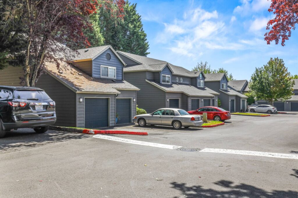 outdoor covered garages with garage doors and cars parked in front of them