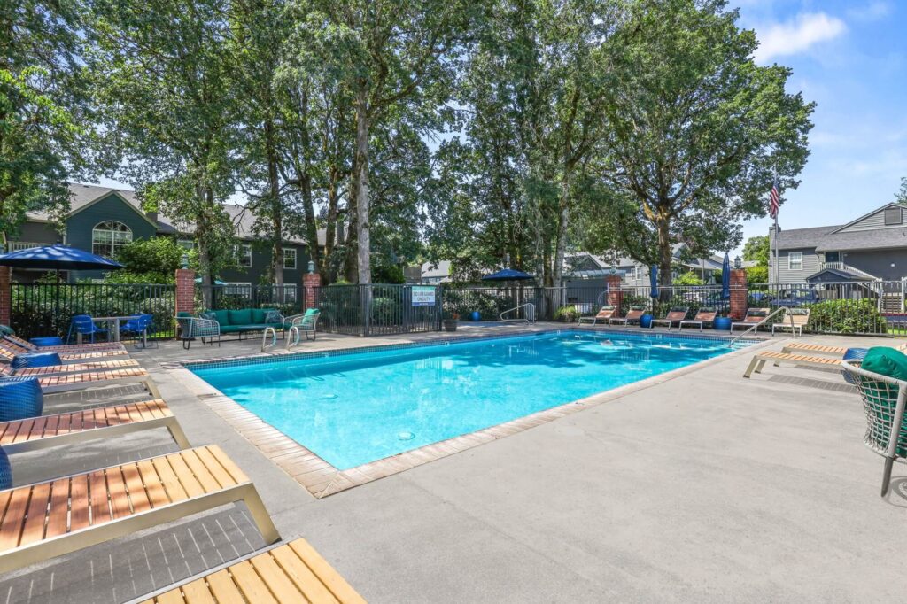 outdoor swimming pool with lounge chairs on patio