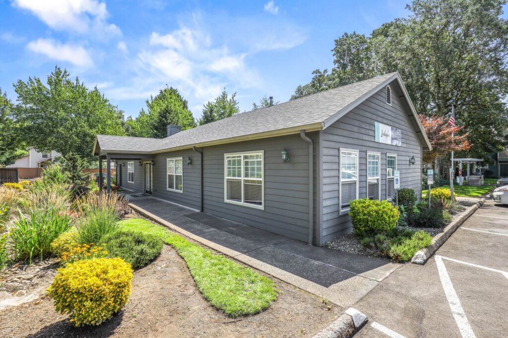 exterior view of leasing office with landscaping and parking lot adjacent